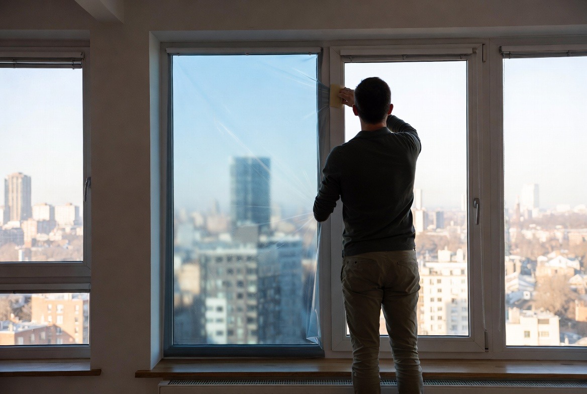 person-install-window-film-on-glass
